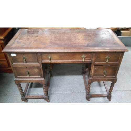 779 - An Antique Oak Desk with well worn leather top. 5 Drawers and Barley Twist Legs on Castors with Bras... 