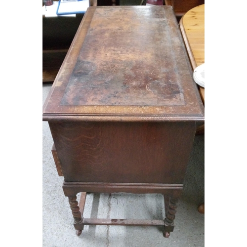 779 - An Antique Oak Desk with well worn leather top. 5 Drawers and Barley Twist Legs on Castors with Bras... 