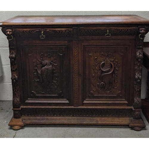 792B - An Oak Heavily Carved Buffet Sideboard with Fish and Foul Motifs.