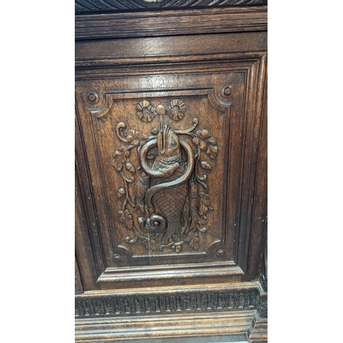 792B - An Oak Heavily Carved Buffet Sideboard with Fish and Foul Motifs.