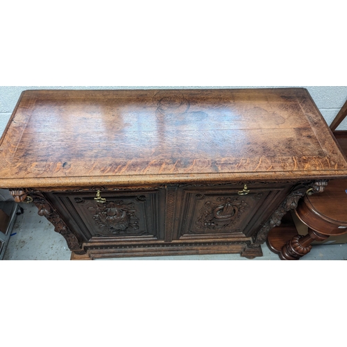 792B - An Oak Heavily Carved Buffet Sideboard with Fish and Foul Motifs.