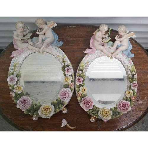 910 - An Antique Pair of Ceramic Cherub Mirrors, some chips and breaks.