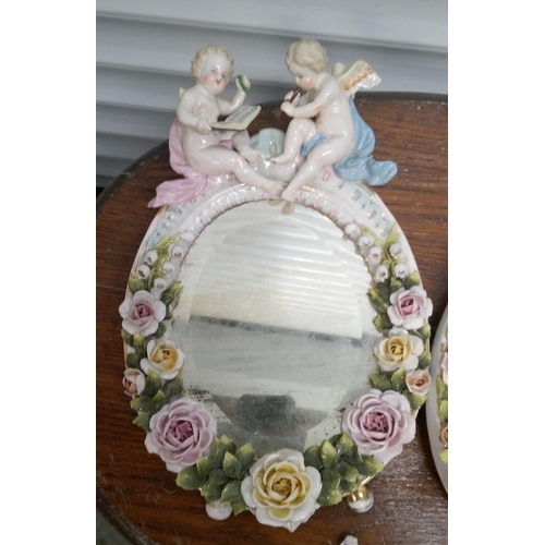 910 - An Antique Pair of Ceramic Cherub Mirrors, some chips and breaks.