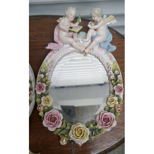 910 - An Antique Pair of Ceramic Cherub Mirrors, some chips and breaks.