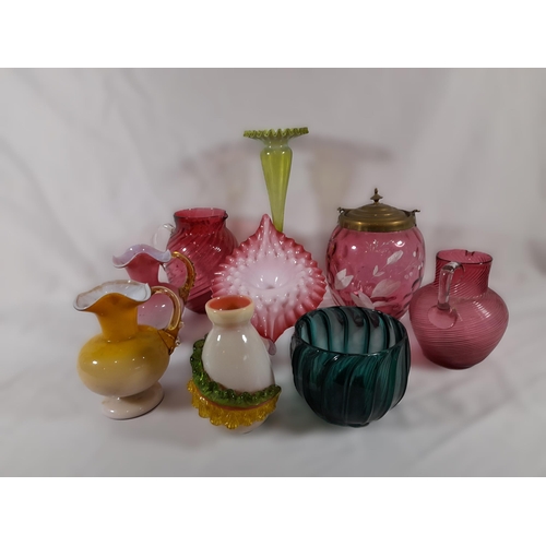 279 - A Mixed Selection of Coloured Glassware including Cranberry and Emerald Glass. Jugs, Vases and more.