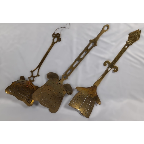 318 - A Set of 3 Antique Brass Cooking Utensils, approx 55cm L.