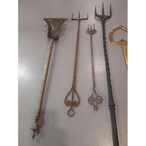 380 - A Collection of Antique Brass Fire Irons including Toasting Forks, 2 Shovels and a Heart Shaped Cook... 