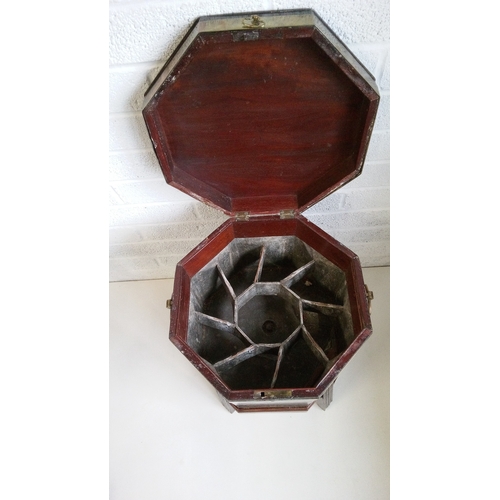 4 - A Mahogany Brass Bound Octagonal wine cooler with lead lined sectional interior. Damage to stand as ... 