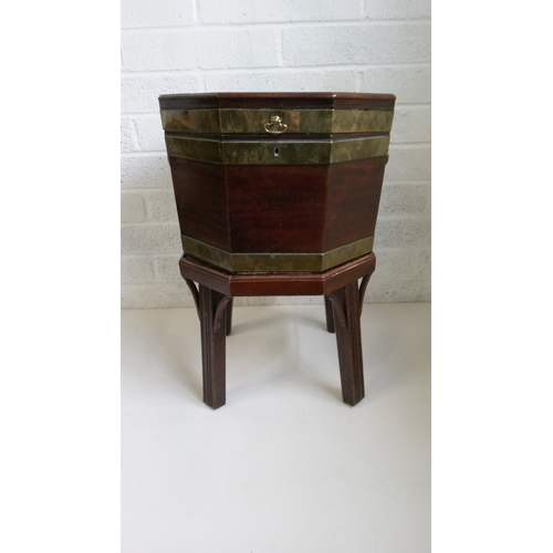 4 - A Mahogany Brass Bound Octagonal wine cooler with lead lined sectional interior. Damage to stand as ... 