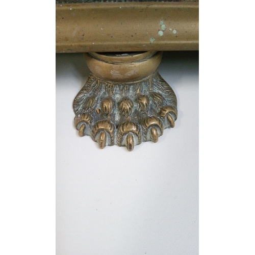 735 - An Antique pierced brass fender with Lions feet and rounded corners.