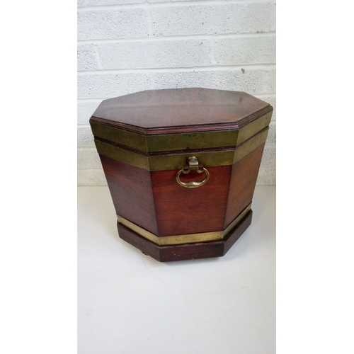 741 - A Mahogany Glass Bound Wine Cooler with wooden
sectional interior on Brass castors.
48cm high, 55x55... 