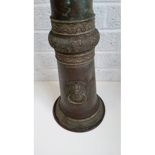 9 - A Tibetan Repousse Brass Rag Dung trumpet Horn. 170 high,27x27cms