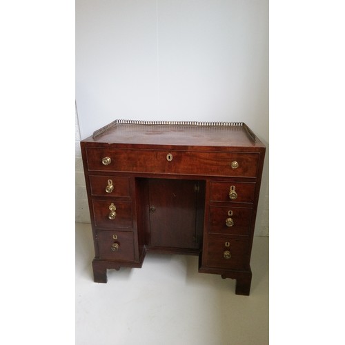 756 - A 7 Drawer Mahogany Desk With Brass Handles, Centre Cupboard And Brass Galley.
80cm High,82cm Wide,4... 