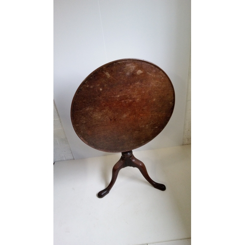 757 - A Round Tilt Top Table With Turned Column And Tripod Legs.