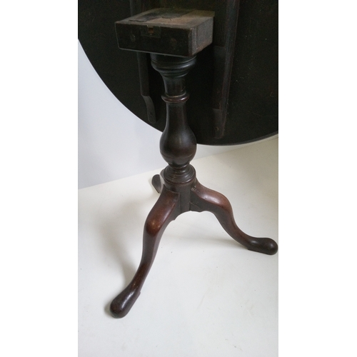 757 - A Round Tilt Top Table With Turned Column And Tripod Legs.