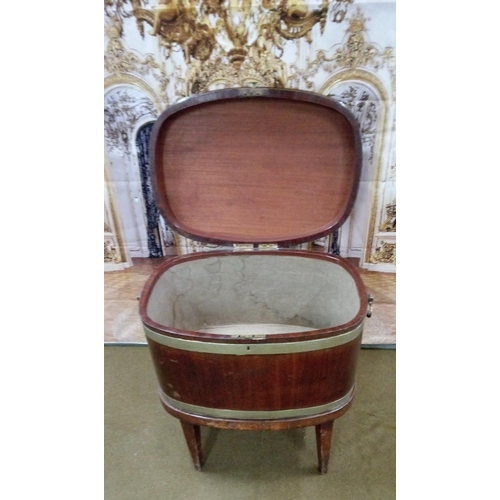 404 - Georgian oval mahogany wine cooler of coopered construction, body and lid with 3 bands of brass.
On ... 