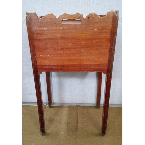 428 - A Georgian bedside commode cabinet with unusual decorative fret work.  On castors