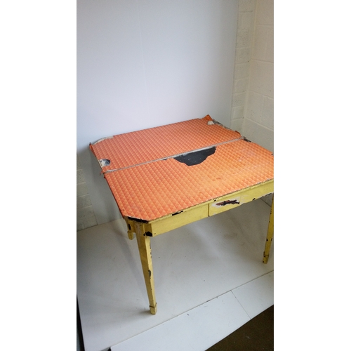 771 - A Yellow Painted Fold Over  Table On Tapered legs.
75cm High,92cm Wide,46cm Deep