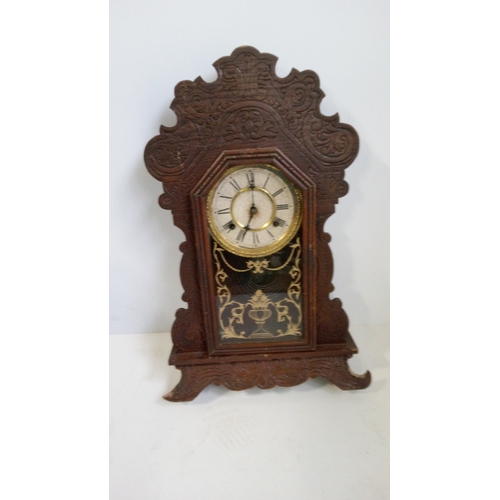 780 - A Waterbury Gingerbread 8 Day Spring Strike Wall Hanging Clock.
58cm High,35cm Wide,
13cm Deep