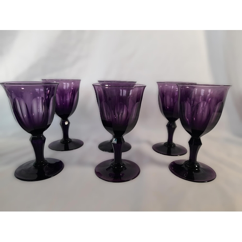 71B - A Collection of Green and Amethyst Glass Goblets and a Green Glass Bowl, the Amethyst Glasses having... 