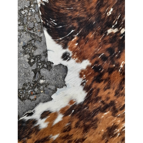 118B - A Large Cowhide Rug.