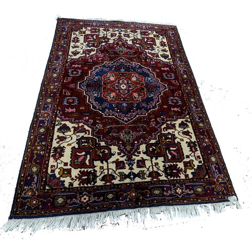 116 - A Large Handmade Wool Rug. 195 x 285cm.