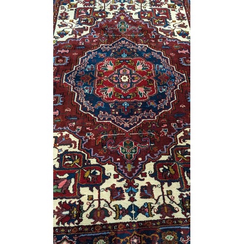 116 - A Large Handmade Wool Rug. 195 x 285cm.