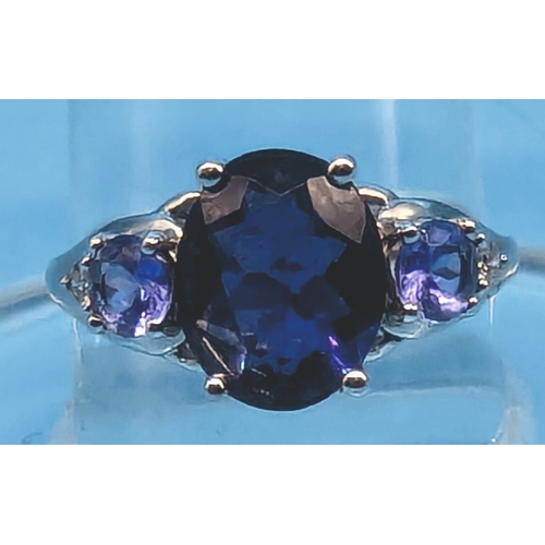 404 - A 9ct White Gold and Tanzanite Ring with a Large Central 2ct Stone with Smaller Tanzanite accents to... 