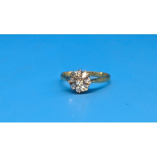 412 - An 18ct Gold and Diamond Daisy Illusion Ring.