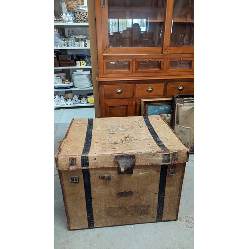 152 - A large canvas and leather bound trunk - initialled 'L.H.' with a crown motif - 89 x 47 x 32 cm