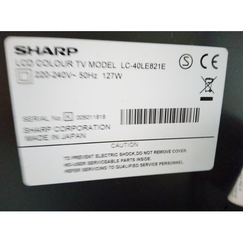 828 - Sharp Aquos TV with Stand and Remote - Model Number LC-40LE821E