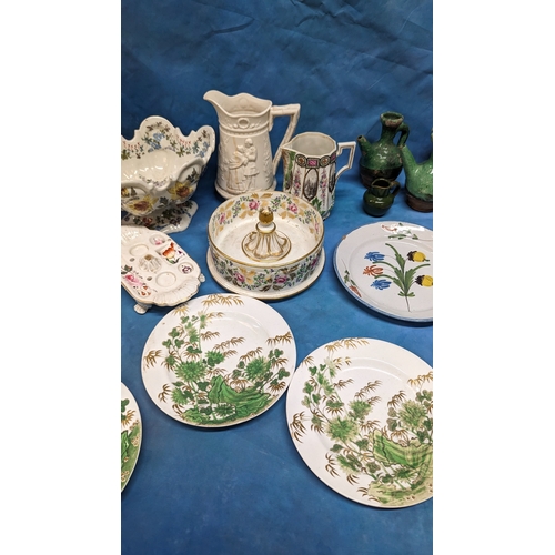 130 - An assortment of antique Chinaware plates and jugs including: Faience and creamware feeding cup, che... 