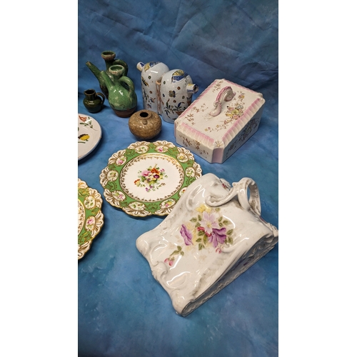 130 - An assortment of antique Chinaware plates and jugs including: Faience and creamware feeding cup, che... 