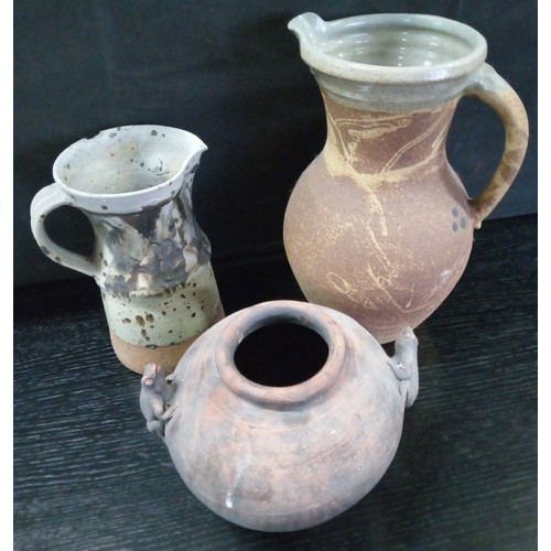 490 - Two Large Studio Pottery Pitchers and an Urn. Smaller Jug has been repaired.