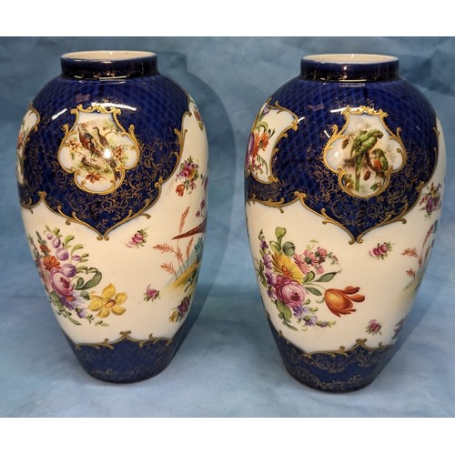 68 - A pair of Worcester exotic bird vases - (holes to bases) - 22cm tall