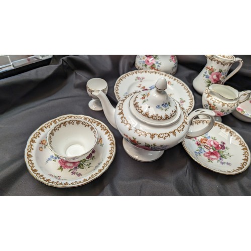 323 - A Quantity of Staffordshire Tea Service x 10 pieces - Rose Design ( slight crack in teapot)