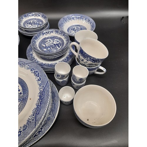 1130 - A Large Quantity of Blue and White Chinaware in Willow Design. Includes a Teapot, 6 Cups, 6 Large Pl... 