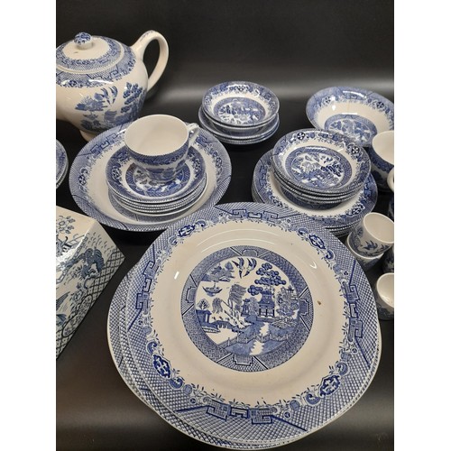 1130 - A Large Quantity of Blue and White Chinaware in Willow Design. Includes a Teapot, 6 Cups, 6 Large Pl... 