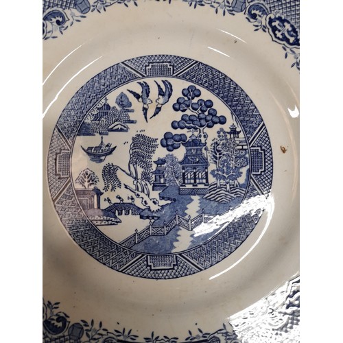 1130 - A Large Quantity of Blue and White Chinaware in Willow Design. Includes a Teapot, 6 Cups, 6 Large Pl... 