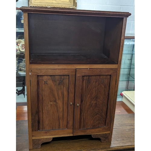 26 - A solid wood 2 door cupboard unit with carved detailing - 56 x 32 x 85cm