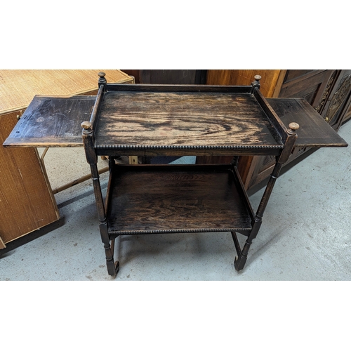 70 - An antique oak drinks / tea trolley with pull out shelves - 62 x 38 x 80cm