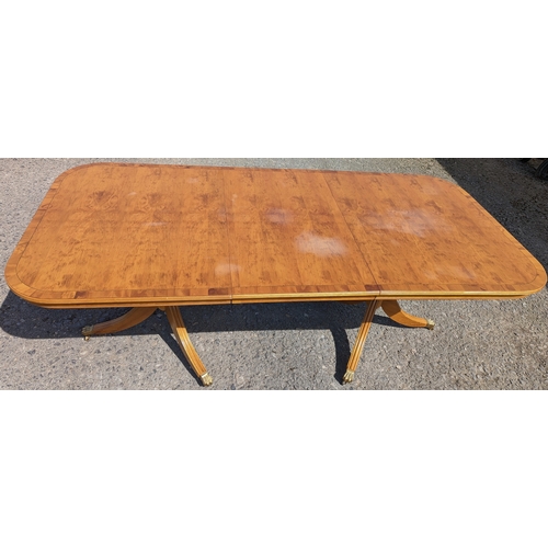 331 - An extending dining table - Yew, on brass casters - 76 x 212 (extended) 157 (closed) x 100cm