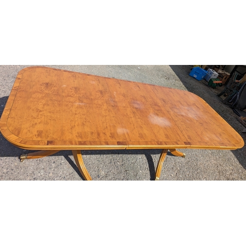 331 - An extending dining table - Yew, on brass casters - 76 x 212 (extended) 157 (closed) x 100cm