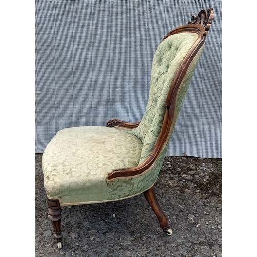 281 - Antique nursing chair with carved detailing and ceramic castors