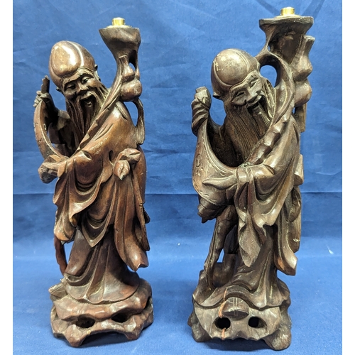 648 - A pair of carved wood Maji lamp bases - 30cm high