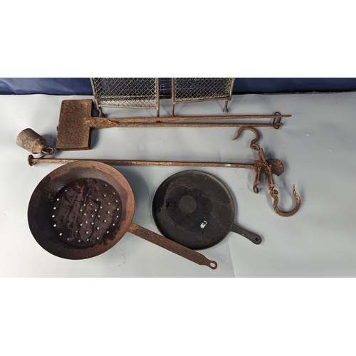 950 - Cast iron waffle iron, antique balance, 2 iron pans and brass fireguard