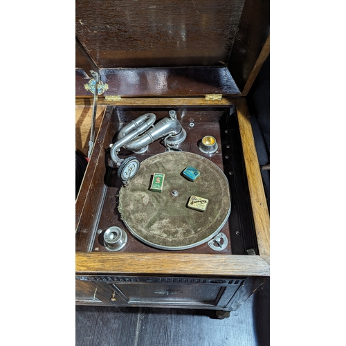 899 - A Gilberts Gramaphone in original cabinet with assorted styluses - one handle missing as pictured - ... 