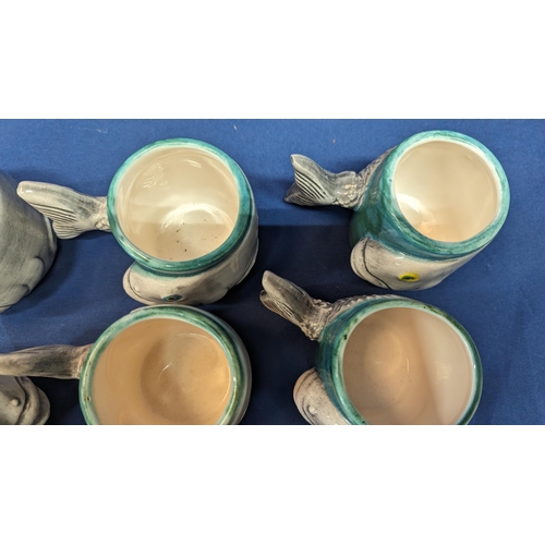 716 - A set of 6 handmade Porcelain Fish mugs with fishtail handles - 8cm tall. 5 with white insides - 1 w... 