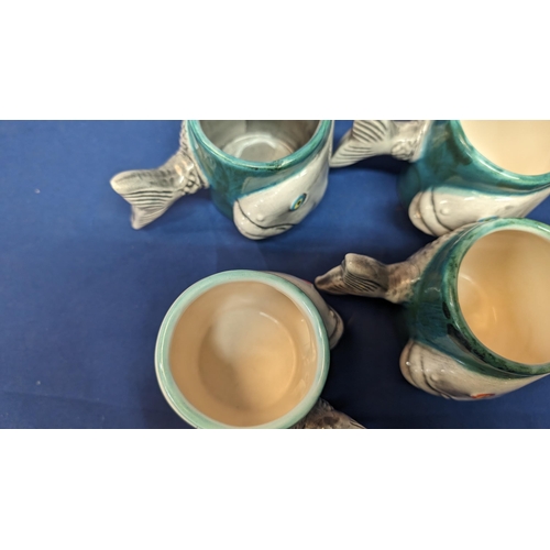 716 - A set of 6 handmade Porcelain Fish mugs with fishtail handles - 8cm tall. 5 with white insides - 1 w... 