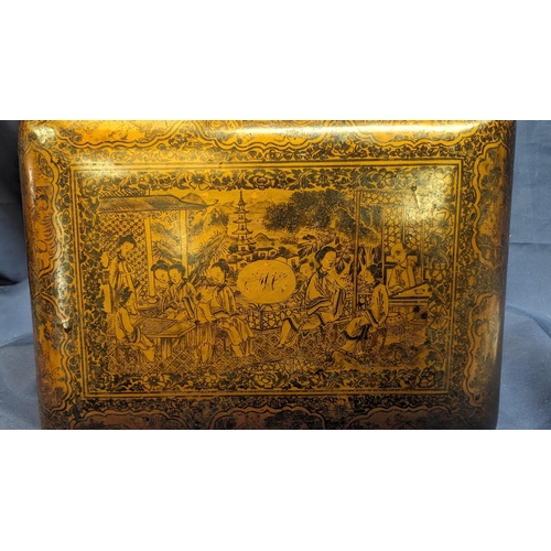 34 - An antique Chinese export lacquered stationary box with internal removeable shelf - Depicts village ... 